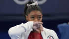 Simone Biles watches after exiting the team final.