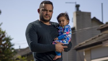 Amit Sachdeva with one of his children. He lost the home he wanted to buy because of a slow approval process.