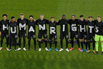 The German soccer team stage a protest at the start of their World Cup qualifier against Iceland in March 2021.