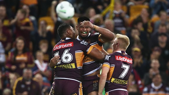 Barnstorming: Broncos forward Payne Haas celebrates his try with teammates.
