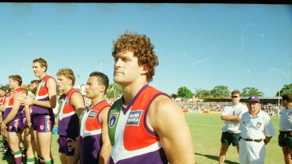 The Dockers, with Ben Allan (right) as captain, line up for the first match against an AFL team, a practice match against Essendon.