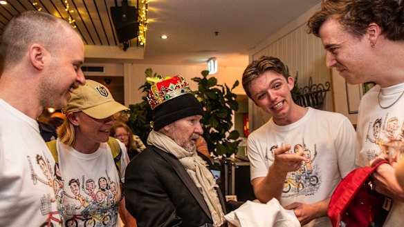 The Herald’s 2022 intake of trainee journalists surprise John Shakespeare with T-shirts printed with his depictions of them. 