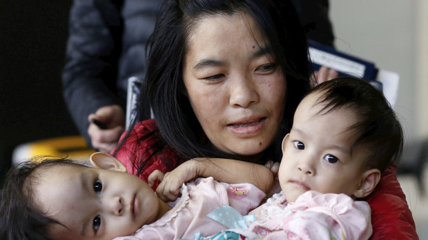 Conjoined twins Nima and Dawa Pelden arrive in Melbourne from Bhutan with their mother. 