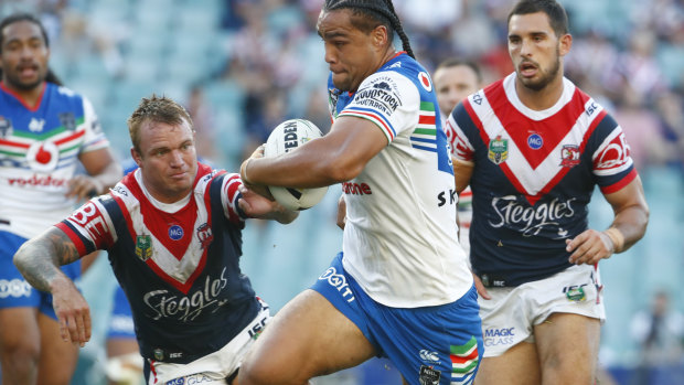 Leivaha Pulu of the Warriors makes a break to score a try against the Roosters.