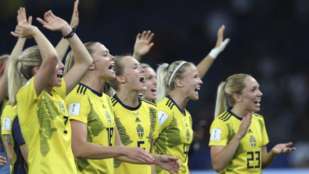 Team spirit: Sweden celebrate after earning a berth in the quarter-finals.