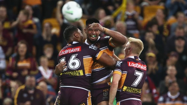 Barnstorming: Broncos forward Payne Haas celebrates his try with teammates.