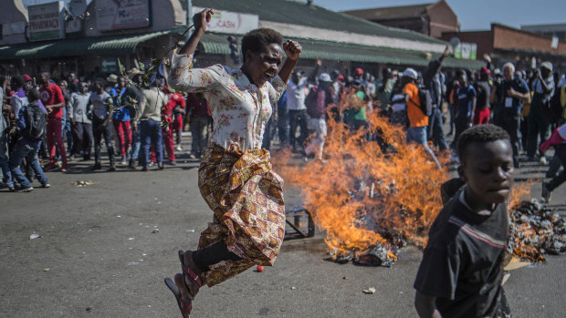 Opposition MDC party supporters protest in the streets of Harare during clashes with police.