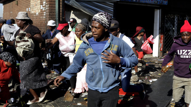 Looters make off with goods from a store in Germiston, east of Johannesburg, South Africa.