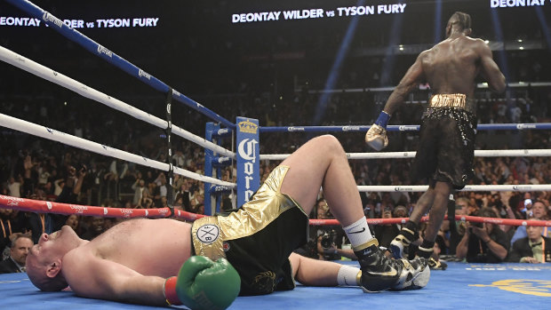Floored: Tyson Fury on the canvas after being knocked down in the 12th round.