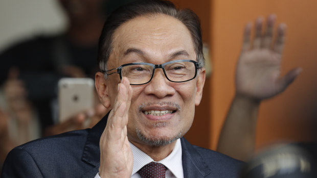 Anwar waves to supporters after his release