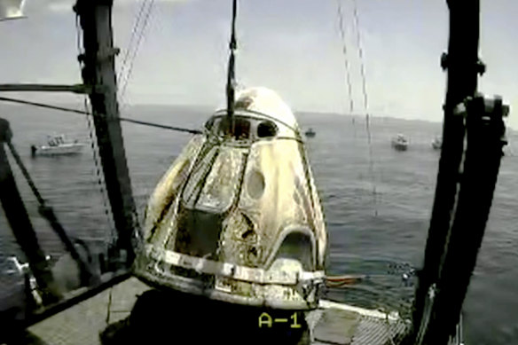 In this frame grab from NASA TV, the SpaceX capsule is lifted onto a ship in the Gulf of Mexico. 
