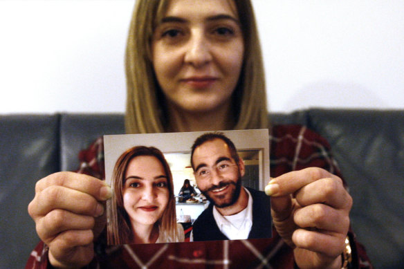Aya al-Umari, whose brother Hussein was killed in the Christchurch mosque attacks, poses, holding a photo of herself and her brother, in Christchurch, New Zealand.