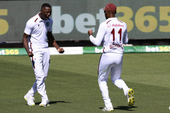 Shamar Joseph celebrates after dismissing Steve Smith in his maiden Test cricket delivery.