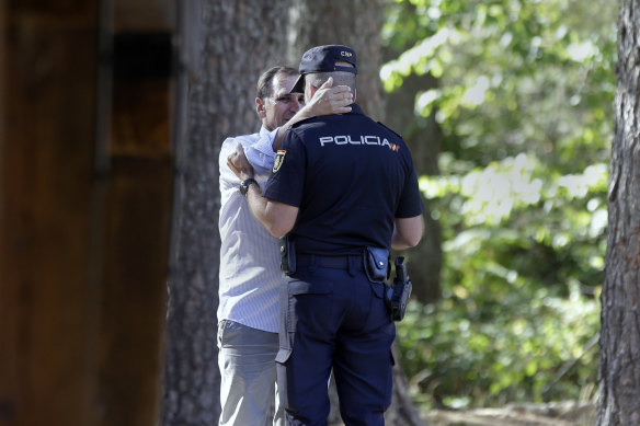 Adrian Federighi, brother in-law of Blanca Fernandez Ochoa, embraces a police officer after the search ended.