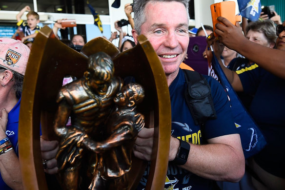 Coach Paul Green holds the NRL trophy on grand final day in 2015 before steering the Cowboys to their only premiership win later in the day.