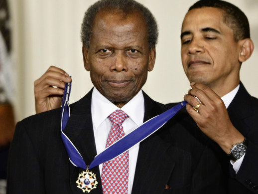 President Barack Obama presents the 2009 Presidential Medal of Freedom to Sidney Poitier during ceremonies in the East Room at the White House.