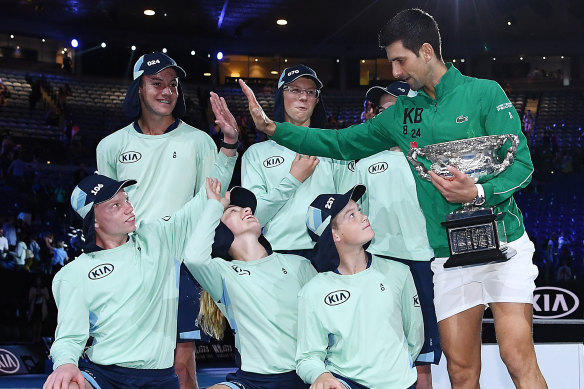 Blake Drury high-fives Novak Djokovic after the Serbian great won the Australian Open in 2020.