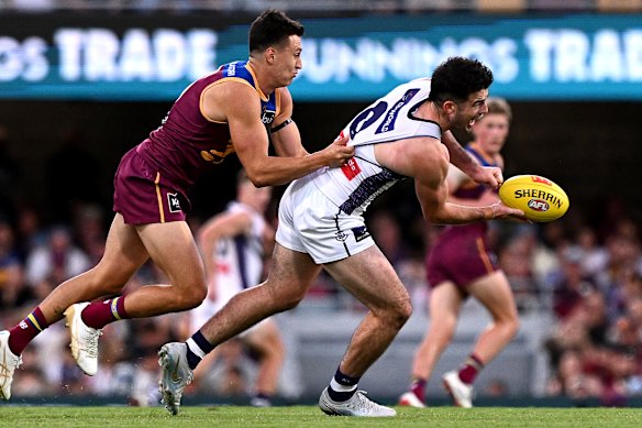 Andrew Brayshaw is pressured by the defence of Hugh McCluggage.