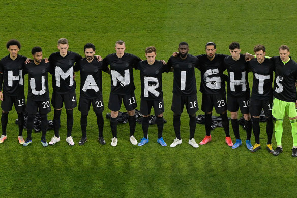 The German soccer team stage a protest at the start of their World Cup qualifier against Iceland in March 2021.