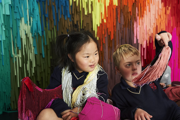Children enjoy the wearable, touchable art of Hello, good to meet you at the MCA's Bella Room.