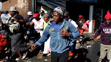 Looters make off with goods from a store in Germiston, east of Johannesburg, South Africa on Tuesday. 