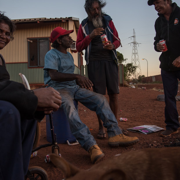 Some of Parnpajinya's remaining Martu residents sit by the fire in the centre of the town-based reserve.