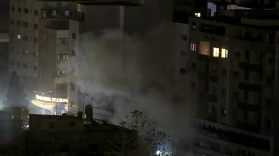 An explosion caused by Israeli airstrikes is seen from a Hamas-affiliated insurance company in Gaza City.