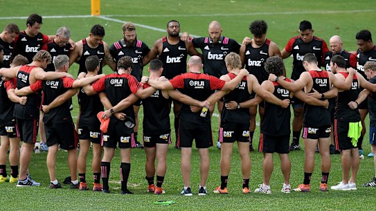 Quiet reflection: Crusaders players and staff pause during their captain's run on Friday in Sydney to remember those who lost their lives in the Christchurch terrorist attack. 