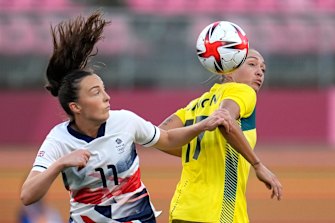 Britain’s Caroline Weir and Australia’s Kyah Simon battle for the ball.