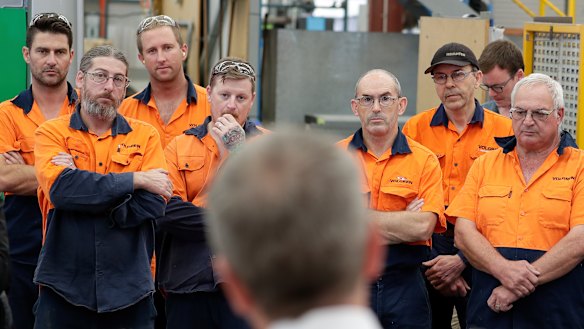 Opposition Leader Bill Shorten, talking to workers at the Volgren bus facility in Perth, will make it easier for casual workers to become permanent. 