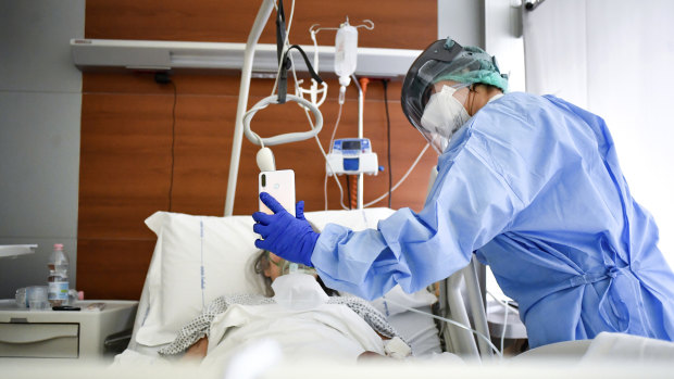 A medical staffer with a COVID-19 patient in Bergamo Hospital, northern Italy.