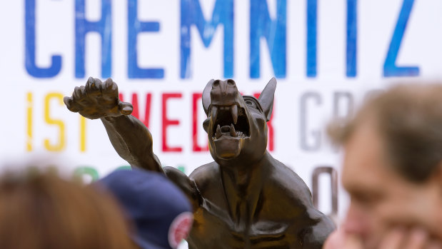 A sculpture by artist Rainer Opolka in front of the Karl Marx Monument in Chemnitz, eastern Germany, one of 10 life-sized metal wolf sculptures as a part of the spontan exhibition 'Wolves with Hitler salute howl in front of the Karl-Marx-Monument', to protest against xenophobia and right-wing extremism. 