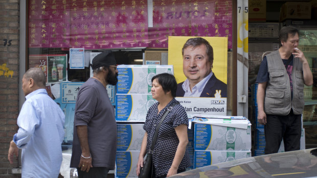 An election poster is displayed in the window of an Asian food store in Antwerp. Belgium, which has one of the oldest compulsory voting systems, will go to the polls for regional, federal and European elections on May 26.