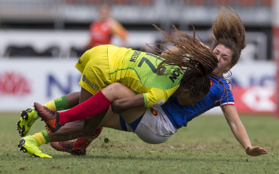 Crunch time: Australian star Ellia Green makes a strong tackle on France's Caroline Drouin.