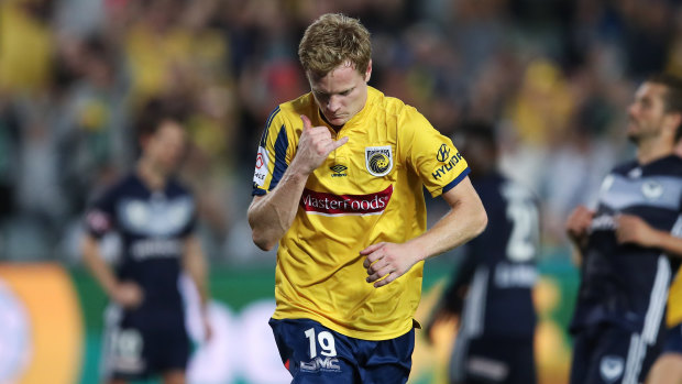Hitting the spot: Matt Simon celebrates after converting a late penalty for the Mariners against Melbourne Victory.