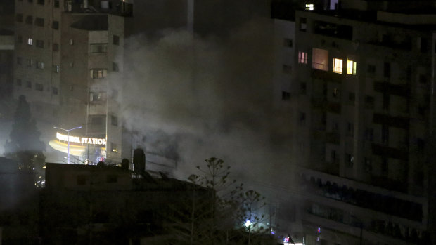 An explosion caused by Israeli airstrikes is seen from a Hamas-affiliated insurance company in Gaza City.