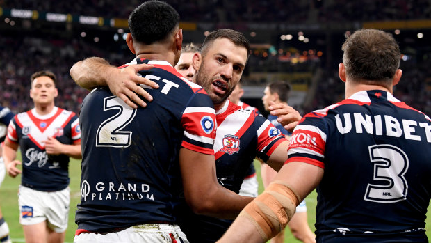 Daniel Tupou of the Roosters is congratulated by James Tedesco after scoring at Suncorp Stadium.