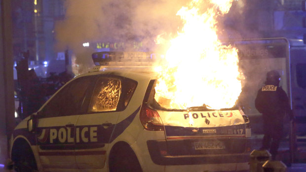 A police car burns after clashes between police and protesters in Marseille, southern France, on Saturday.