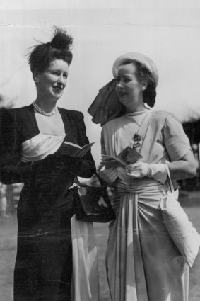 "Mrs. Ronald Nott, of Melbourne, who has been in Sydney for Easter Week festivities, wore an unusual black crepe frock draped in ice blue satin to Randwick yesterday. With Mrs. Nott was her sister, Miss Betty Smith. April 8, 1947."
