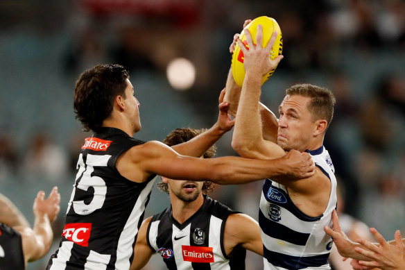 Joel Selwood, right, is tackled by Nick Daicos.