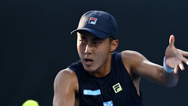 MELBOURNE, AUSTRALIA - JANUARY 14: Rinky Hijikata of Australia plays a backhand against Mitchell Krueger of the United States in the Men’s Singles First Round match during day three of the 2025 Australian Open at Melbourne Park on January 14, 2025 in Melbourne, Australia. (Photo by Quinn Rooney/Getty Images)