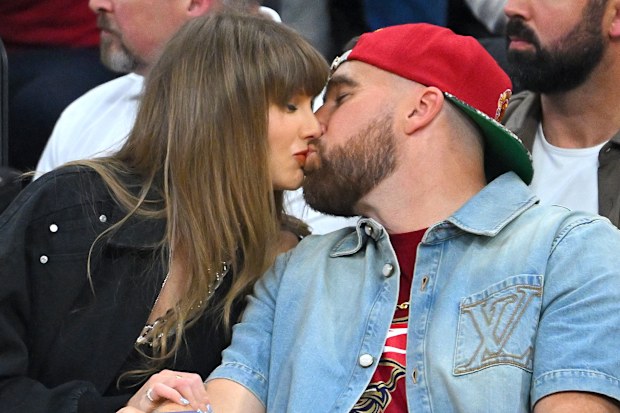 Singer Taylor Swift and Travis Kelce of the Kansas City Chiefs kiss during Game Three between the New York Knicks and the Cleveland Cavaliers in the NBA Eastern Conference Finals at Rocket Arena on May 23, 2026 in Cleveland, 