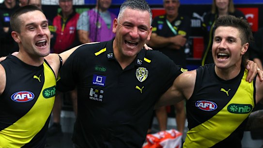 Adem Yze celebrates his first win as  Richmond coach with Jayden Short and Liam Baker under his arms.