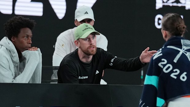 Twelfth seed Elina Svitolina listens as her coach Andrew Bettles and husband Gael Monfils, left, give her advice during her fourth round match against Mirra Andreeva on Sunday.