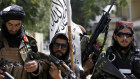 Taliban fighters display their flag on patrol in Kabul, Afghanistan. Aid agencies will have to deal with them.