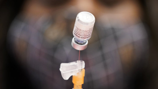A certified medical assistant prepares a dose of the Pfizer-BioNTech COVID-19 vaccine at a vaccination.