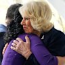 The Queen embraces a relative of a victim of the 9/11 attacks at the memorial.