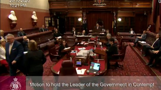 Don Harwin being escorted out of the NSW Legislative Council on Tuesday night.
