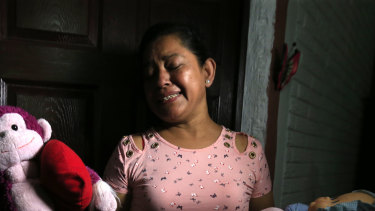 Rosa Ramirez sobs as she shows journalists toys that belonged to her nearly 2-year-old granddaughter Valeria in her home in San Martin, El Salvador.