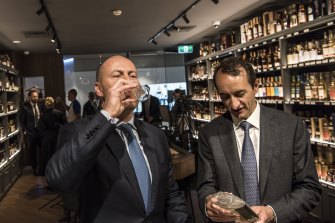 Josh Frydenberg enjoys a sample at Double Bay’s World of Whisky with Dave Sharma on Wednesday.
